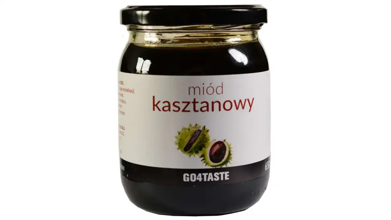 Słoik ciemnego miodu kasztanowego z etykietą przedstawiającą owoce kasztanowca. Miód kasztanowy właściwości cenione od lat.